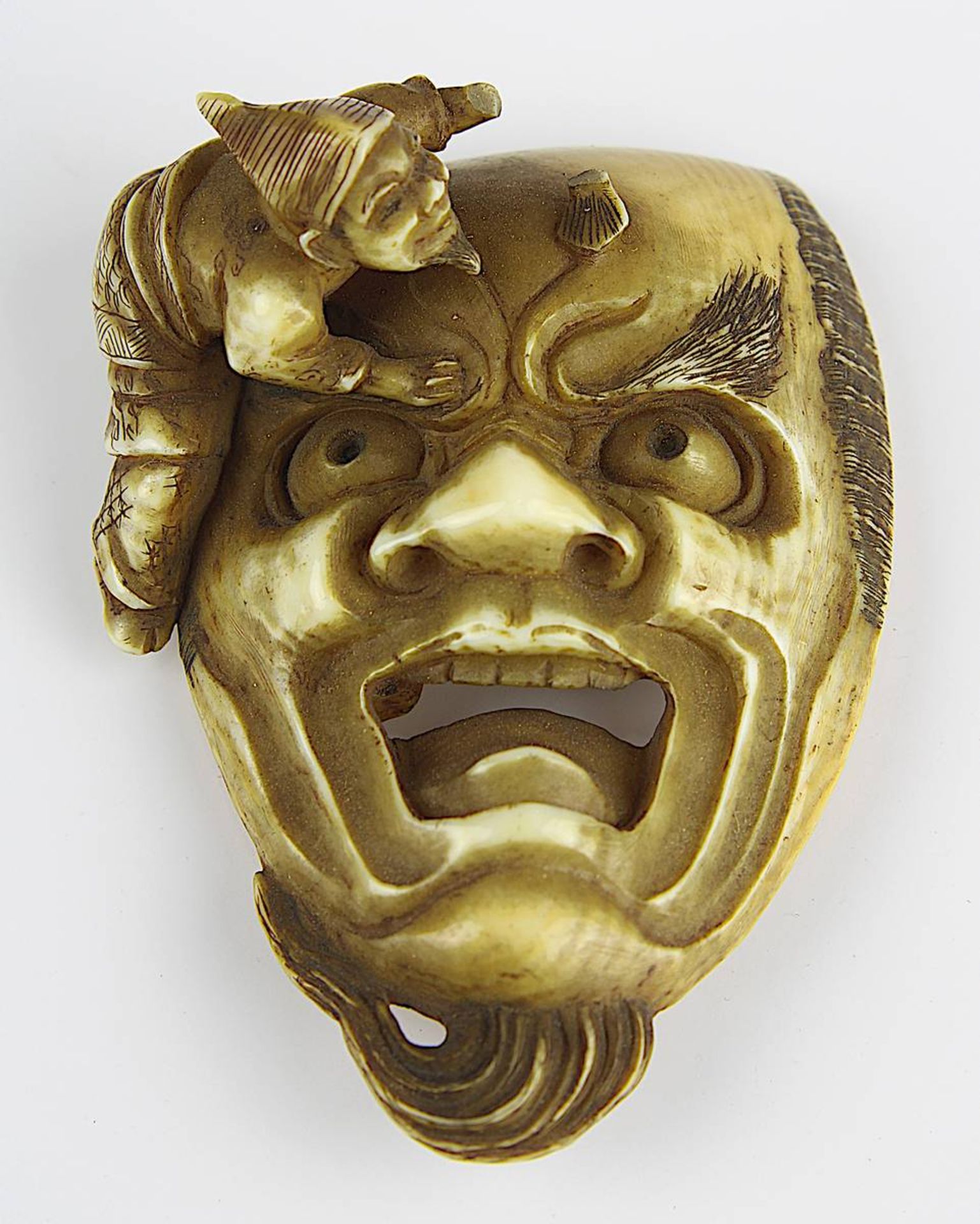 Japanisches Elfenbein-Netsuke, Meji-Periode, fein geschnitzte Darstellung eines Gesicht mit