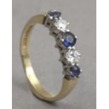 A diamond and sapphire five stone ring