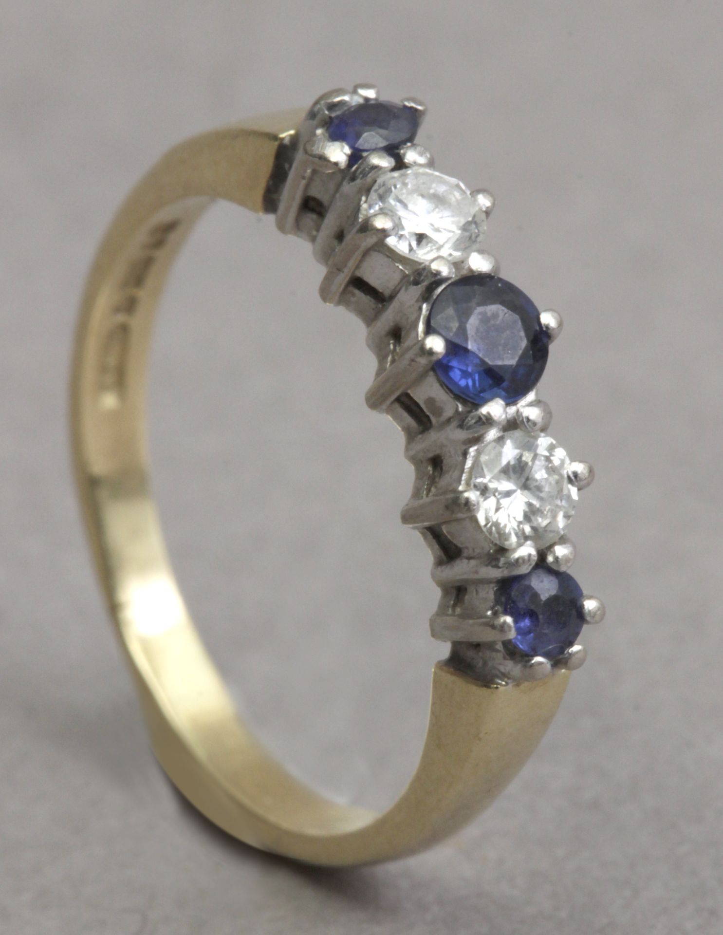 A diamond and sapphire five stone ring