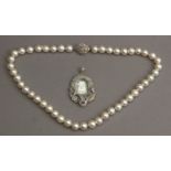 An Art-Déco devotional medal and a cultured pearl necklace