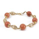 A mid 20th century coral beads and 18k. yellow gold bracelet