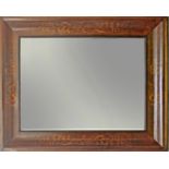 A 19th century Fernandino mahogany mirror with a carved pine inside