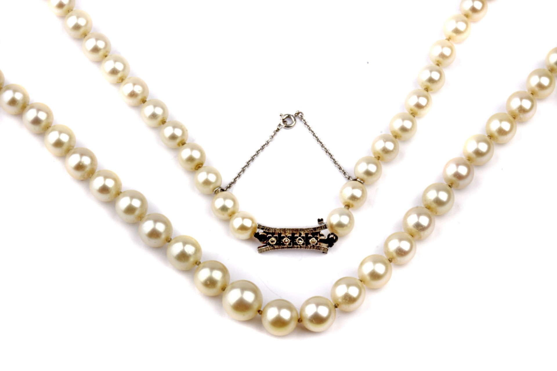 A cultured pearls necklace with a white gold and diamond clasp