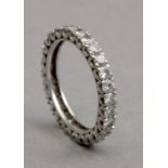 A diamond eternity ring with an 18k. white gold setting