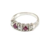 A five stone ruby and diamond ring with an 18k. white gold setting