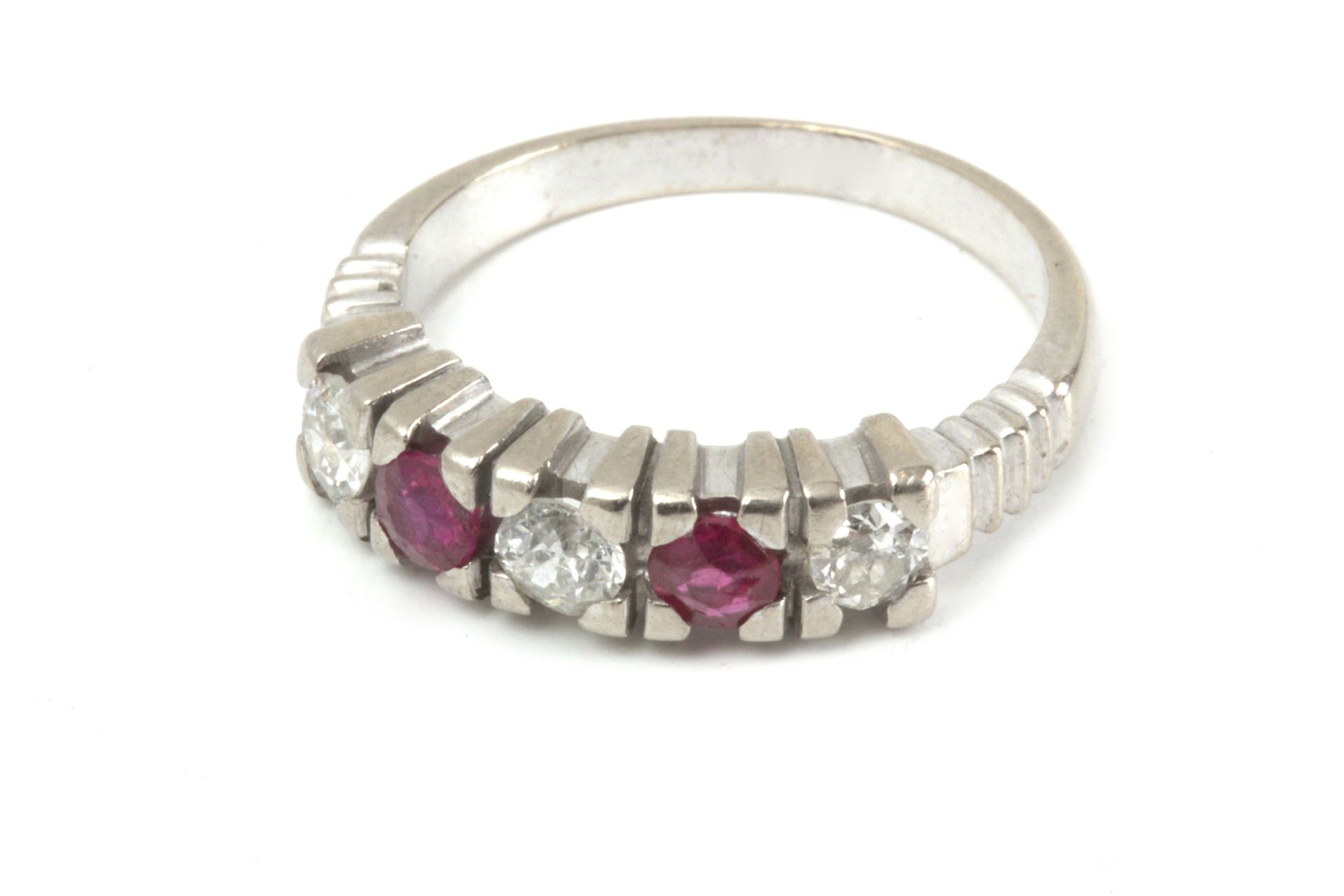 A five stone ruby and diamond ring with an 18k. white gold setting