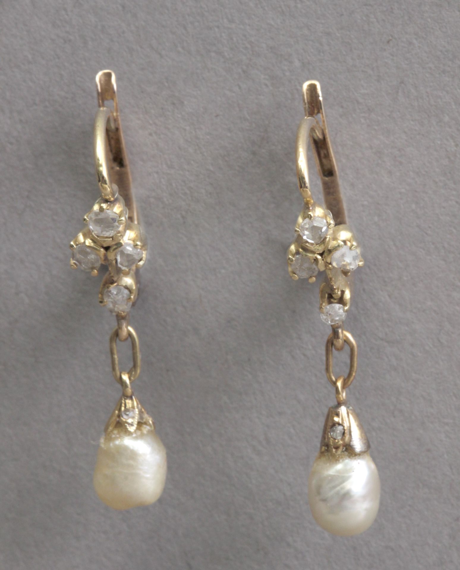 A pair of early 20th century earrings. Yellow gold, rose cut diamonds and pearls