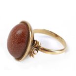 A mid 20th century aventurine glass ring with an 18k. yellow gold setting
