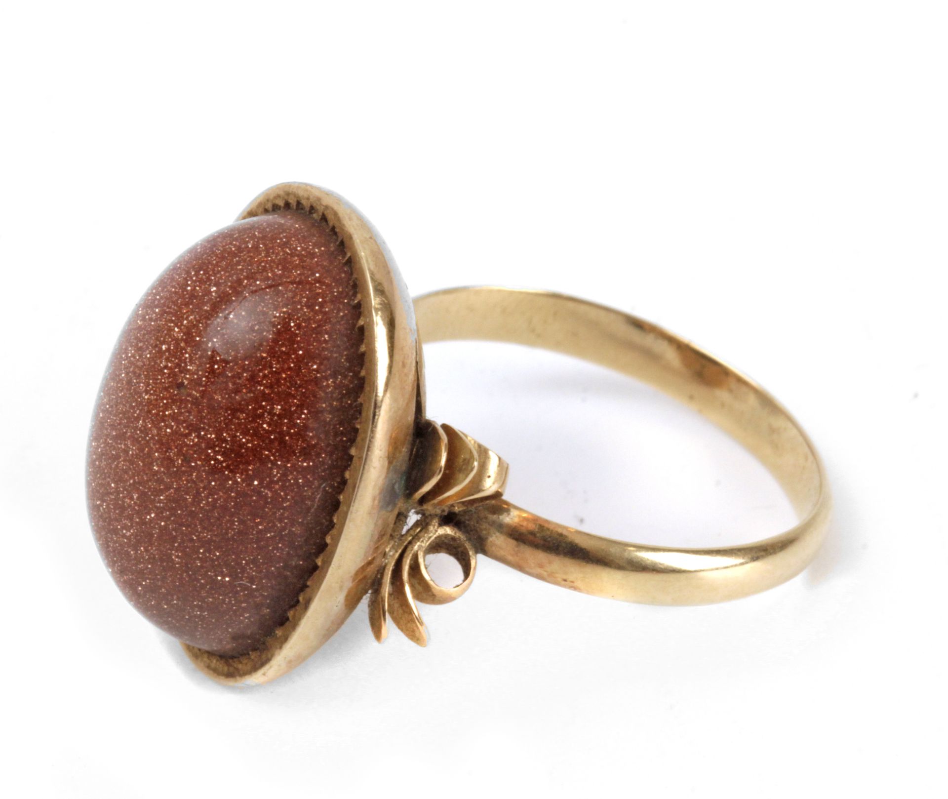 A mid 20th century aventurine glass ring with an 18k. yellow gold setting