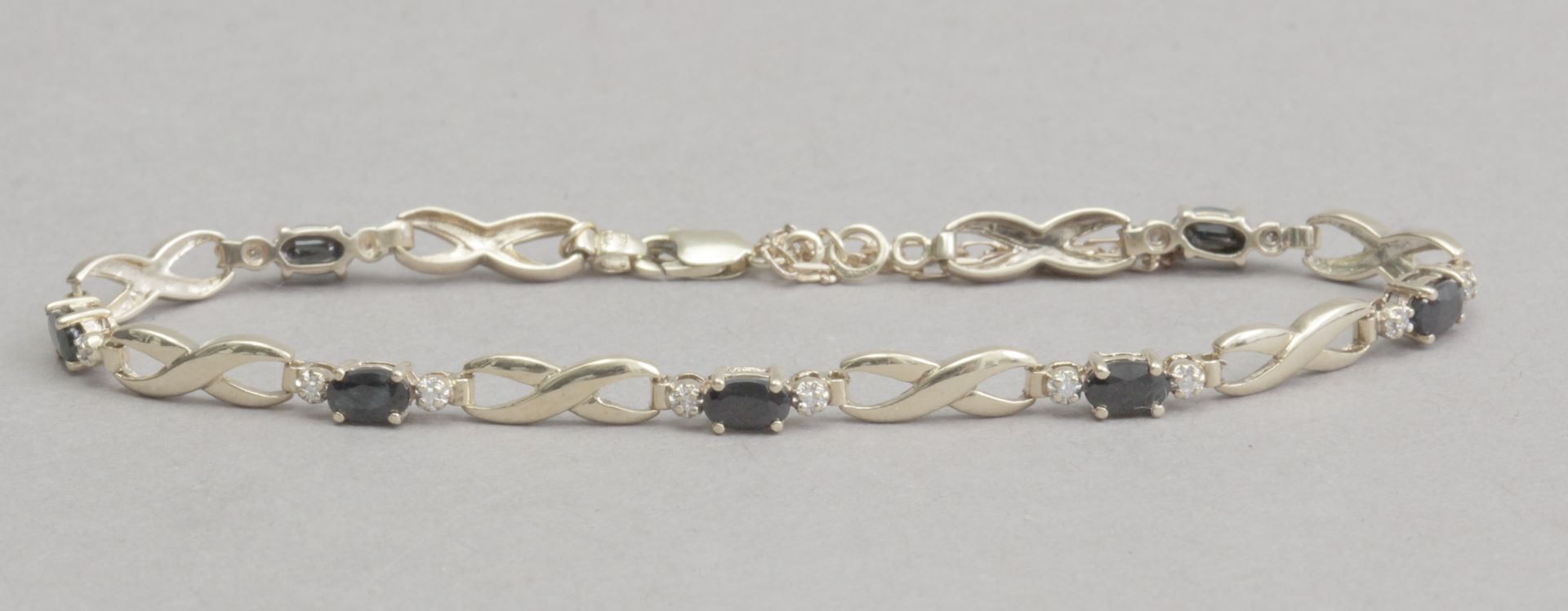 A sapphire and diamond bracet with a 14k. yellow gold setting