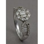 A diamond cluster ring in an 18k. white gold setting