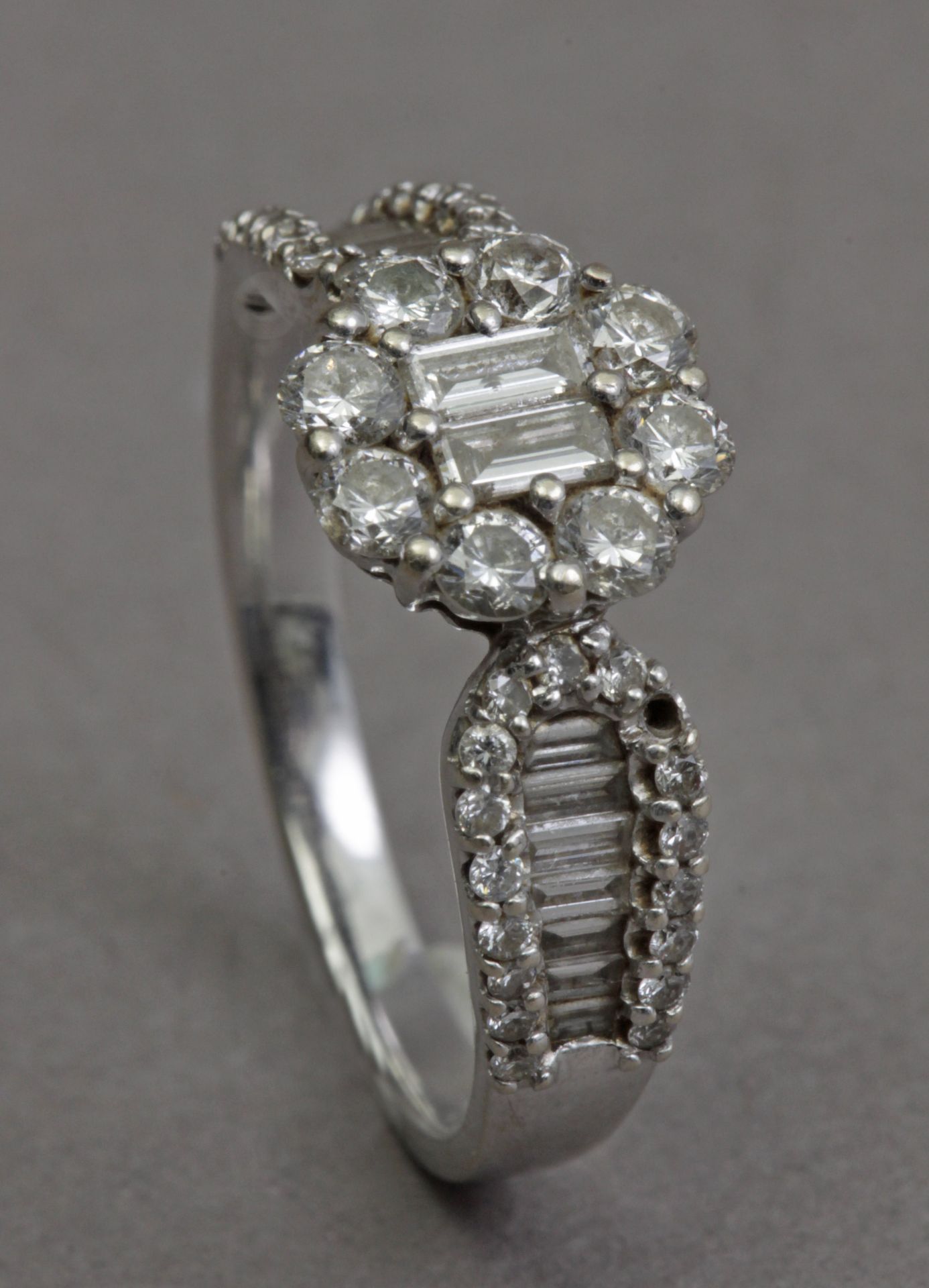 A diamond cluster ring in an 18k. white gold setting