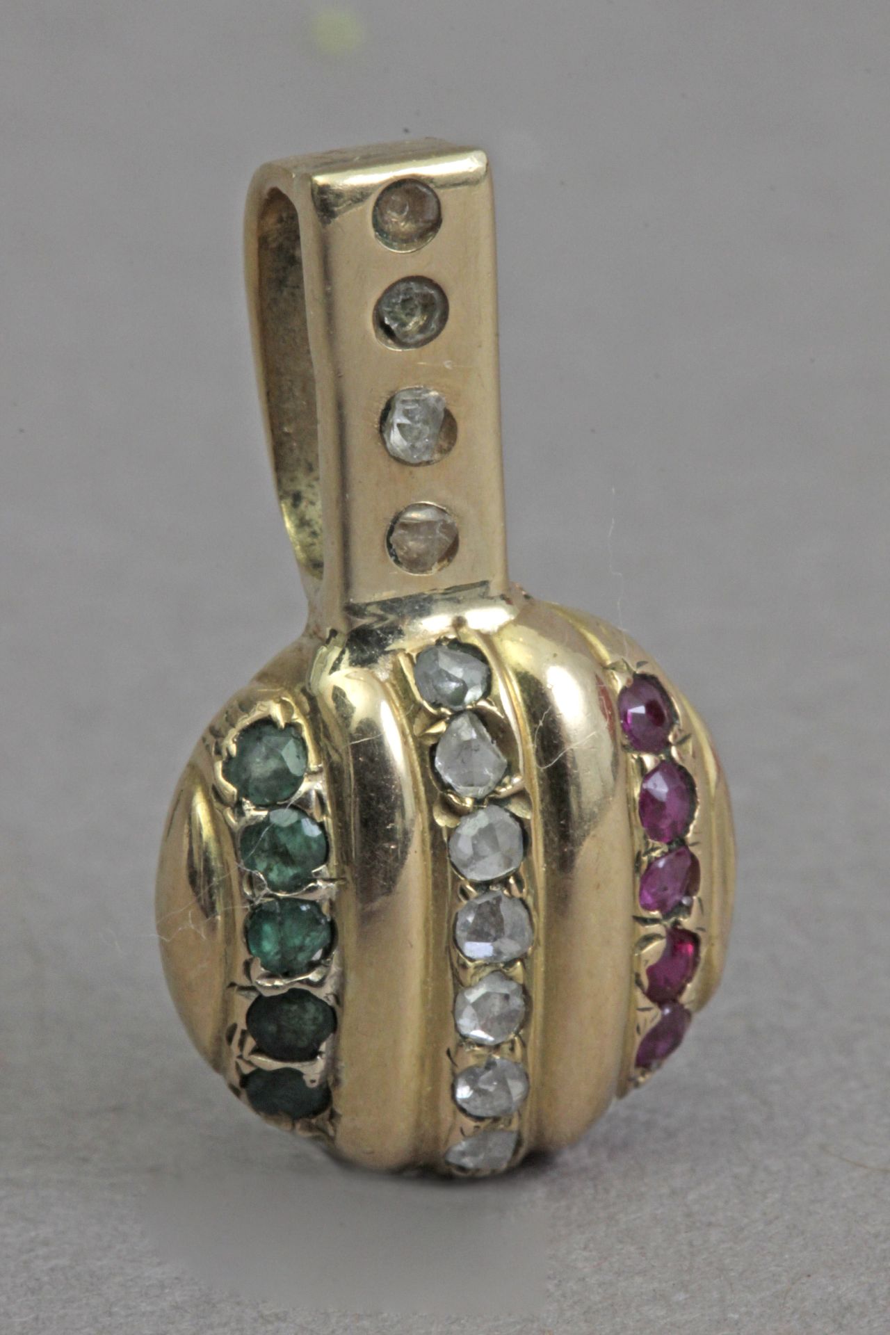 A rubies, emerald,and sapphire pendant with an 18k. yellow gold setting