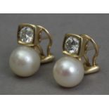 A pair of diamond and pearl 'toi et moi' earrings