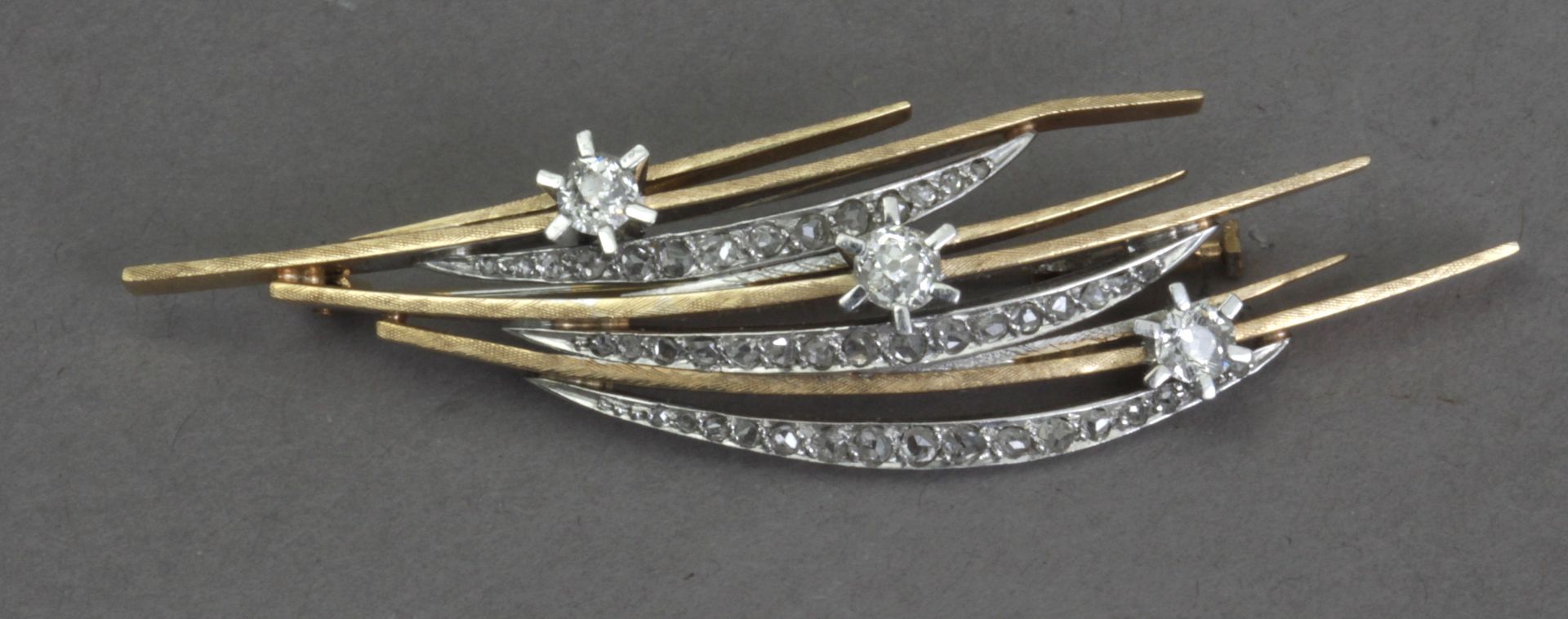 A diamond brooch with a gold setting