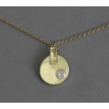 A diamond and gold pendant and chain