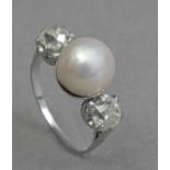 A first third of 20th century three stone diamonds and pearl ring