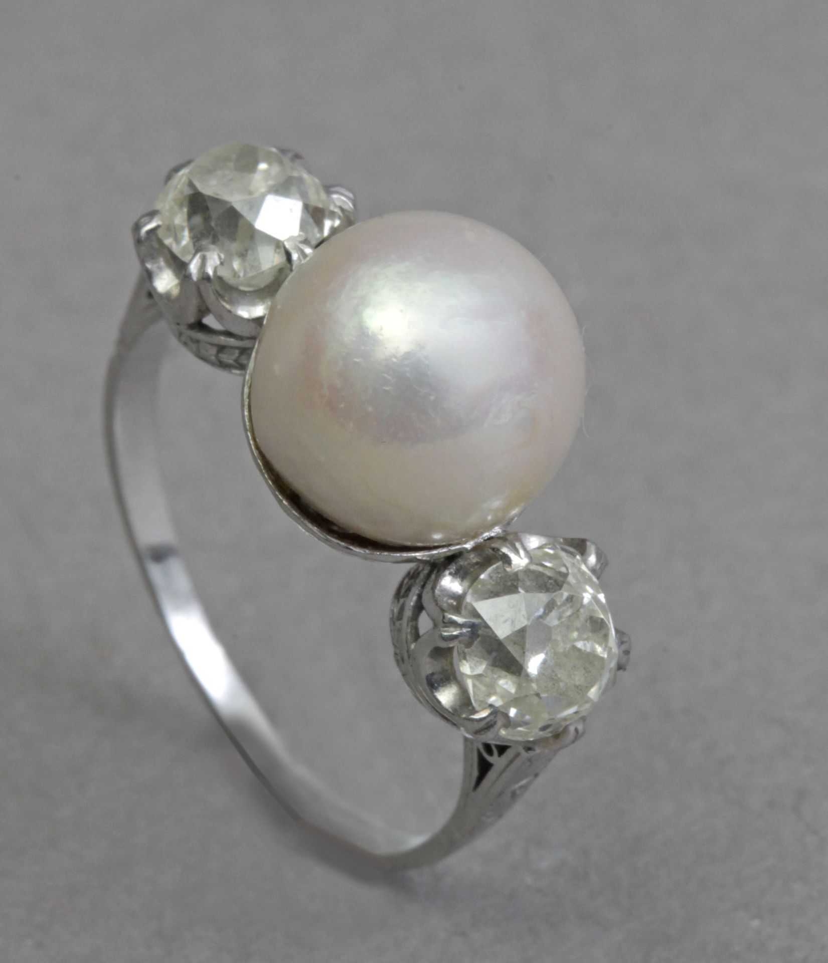 A first third of 20th century three stone diamonds and pearl ring