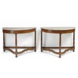 A pair of 20th century Empire style half moon walnut console tables