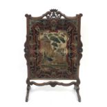 A 19th century French oak and petit point fire screen