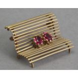 A mid 20th century gold and rubies brooch