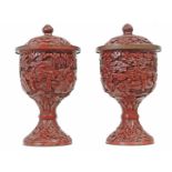 A pair of 18th century cinnabar lacquer vases and covers