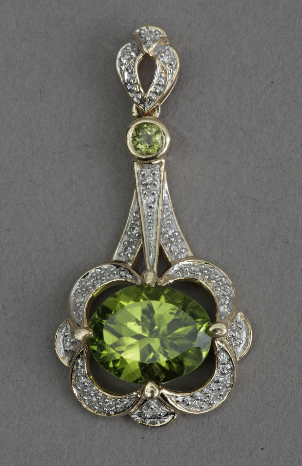 A diamond and diopside pendant in an 18k. yellow gold setting