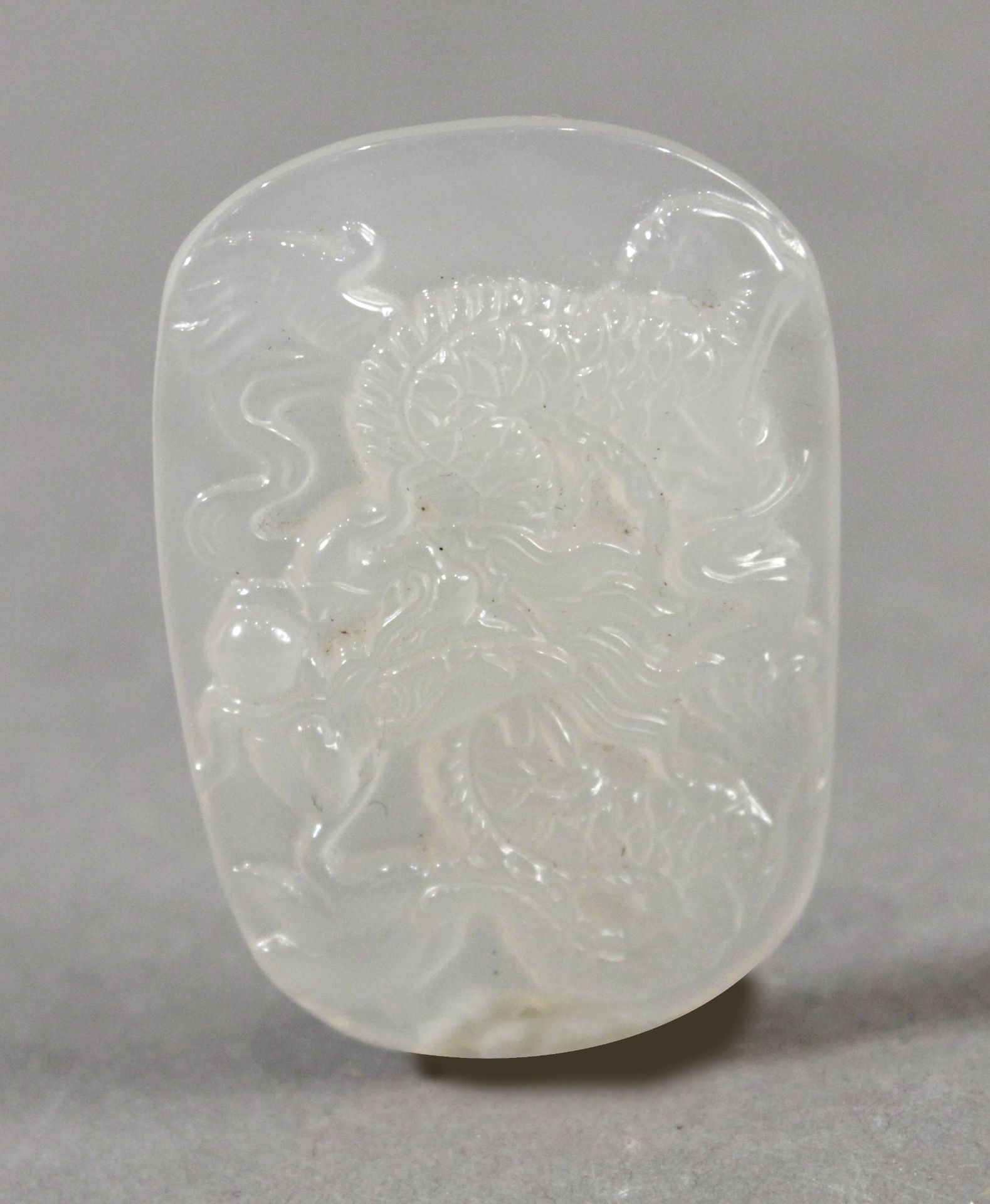 An early 20th century Chinese pendant in carved jade