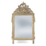 A late 18th century Louis XVI mirror in carved and gilt mirror