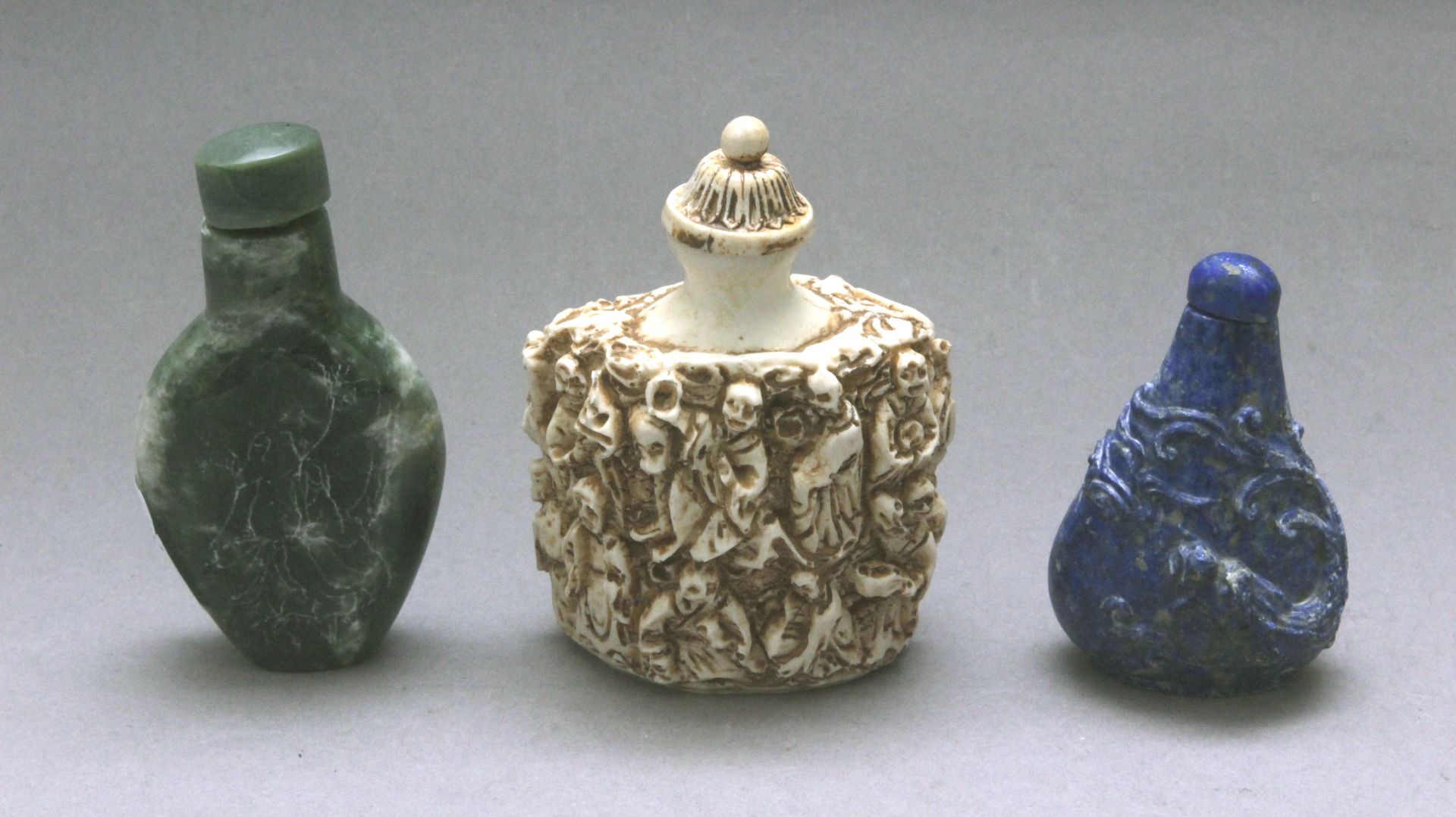 A set of three 20th century Chinese snuff bottles in carves lapis lazuli, meerschaum and serpentine