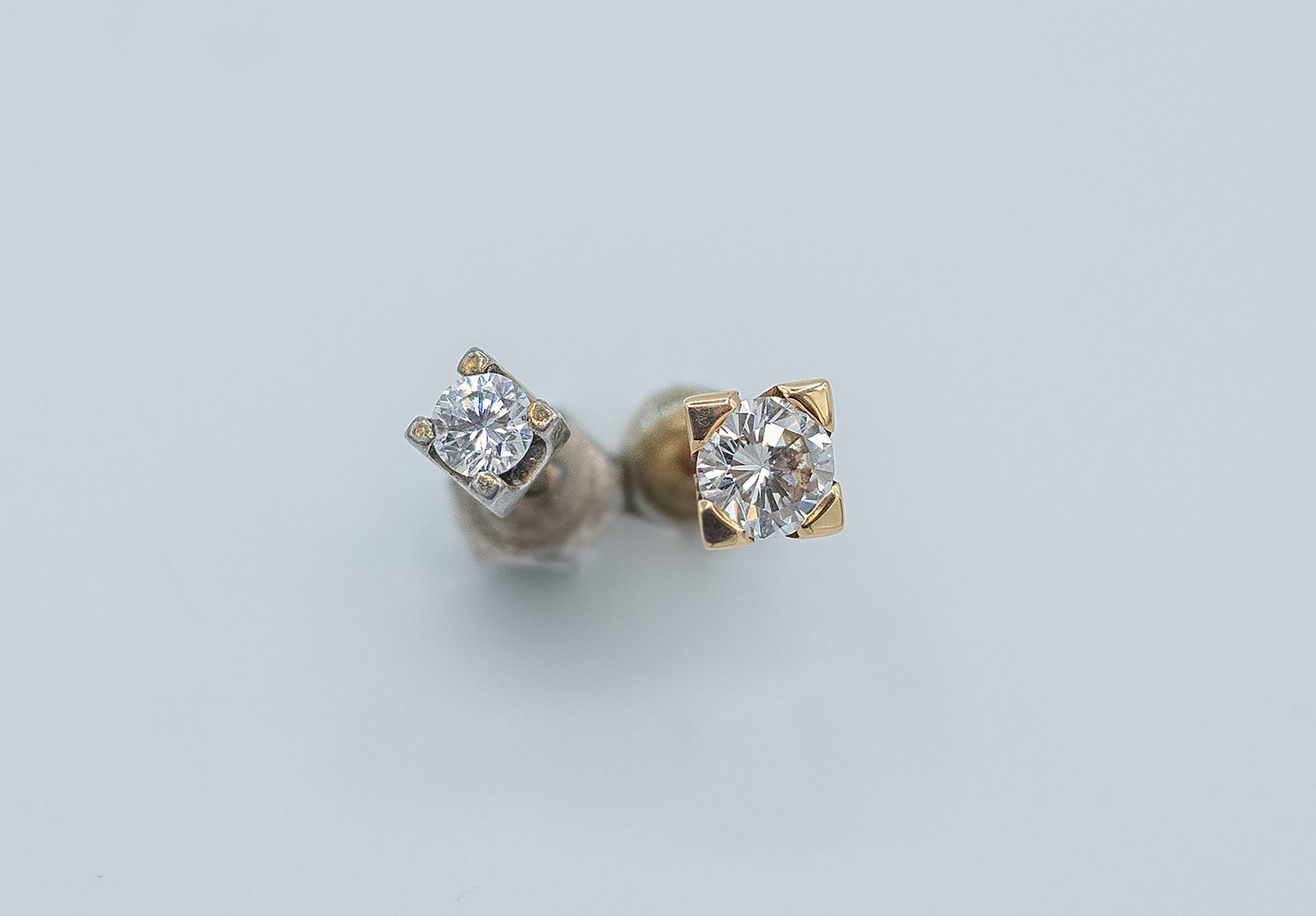 Two diamond stud earrings