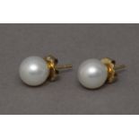 A pair of Australian pearl stud earrings with 18k. yelllow gold setting