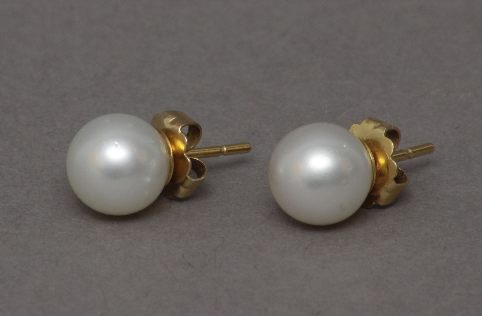 A pair of Australian pearl stud earrings with 18k. yelllow gold setting