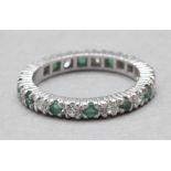A brilliant cut diamonds and emeralds eternity ring