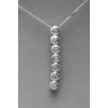 A brilliant cut diamonds pendant with a bezel setting