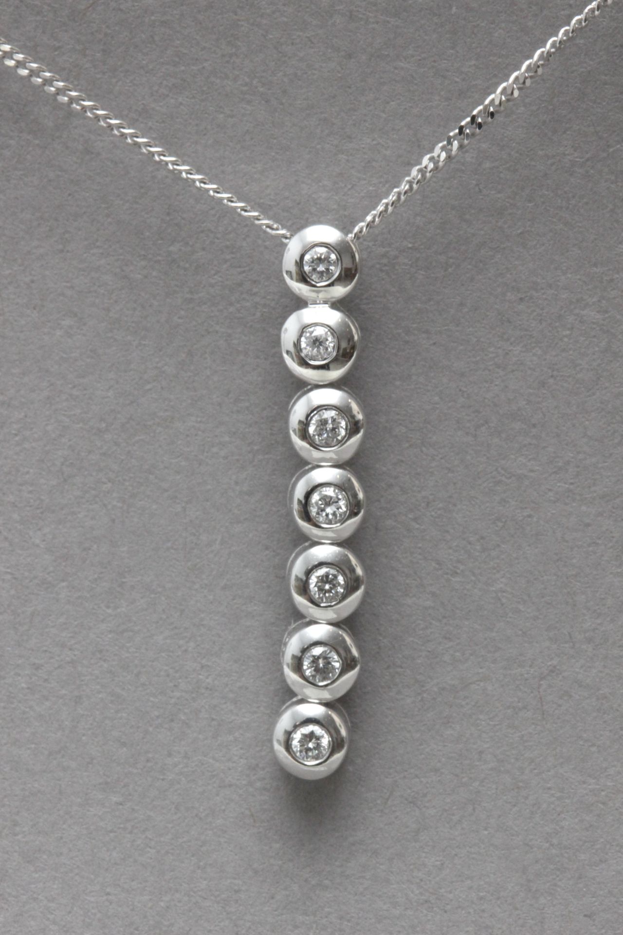 A brilliant cut diamonds pendant with a bezel setting