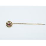 A mid 20th century gold and garnet tie pin