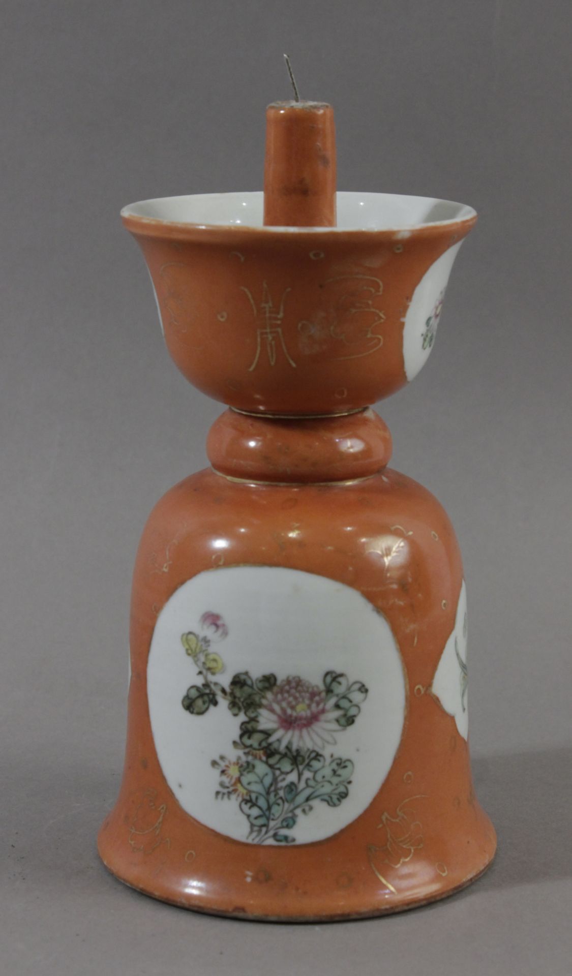 An early 20th century Chinese candle stick from Qing dynasty in Famille Rose porcelain