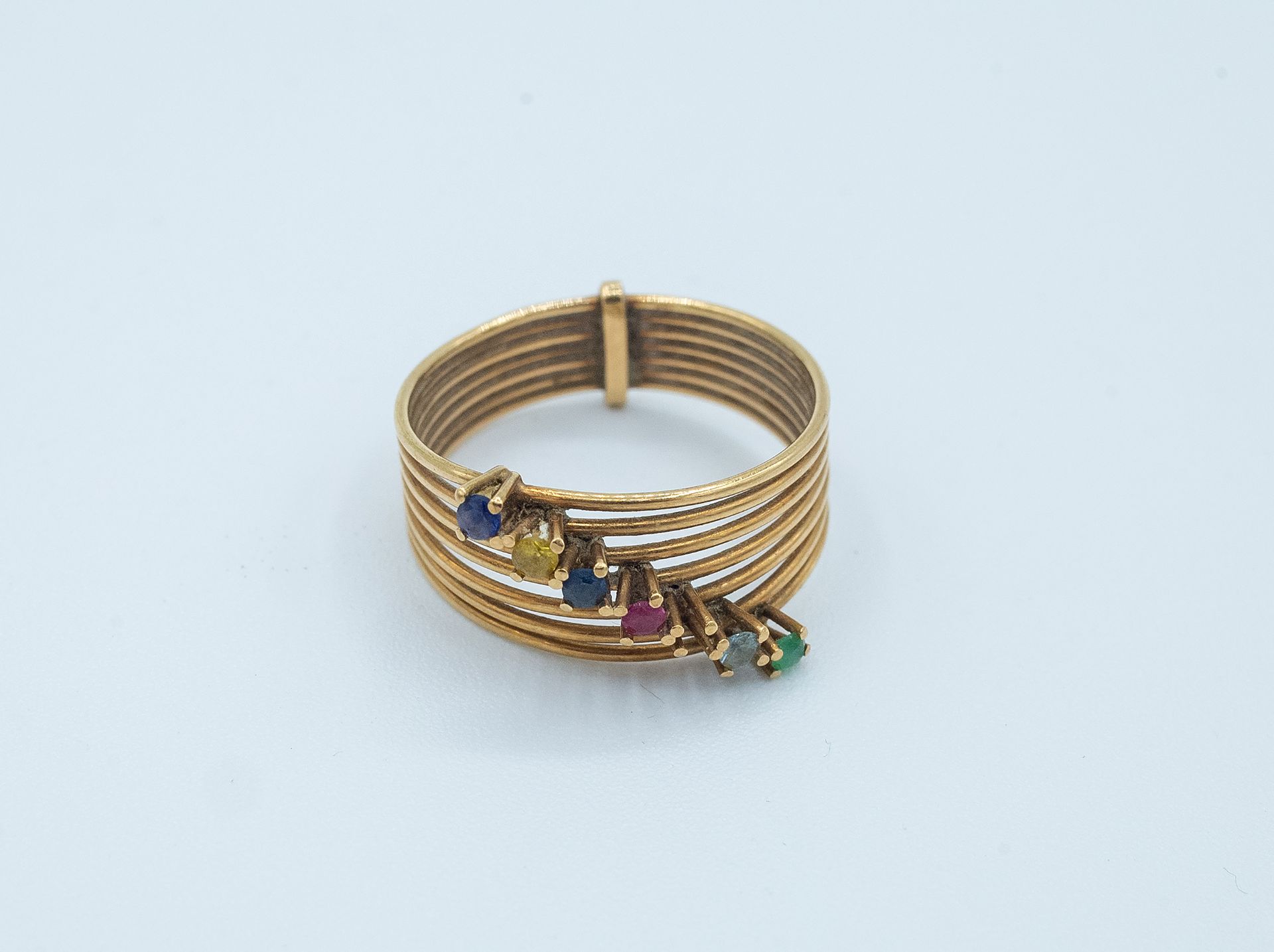 An 18k. yellow gold ring and colour stones