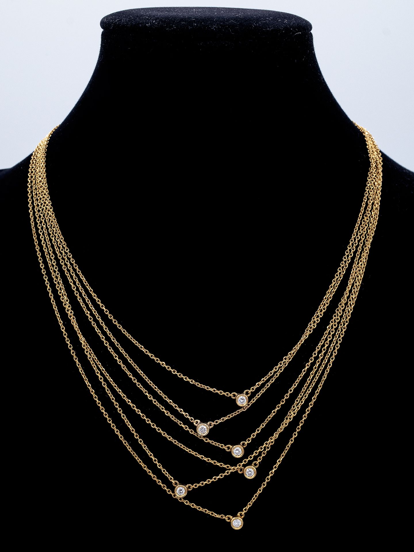 A six strand 18k. yellow gold and diamonds necklace