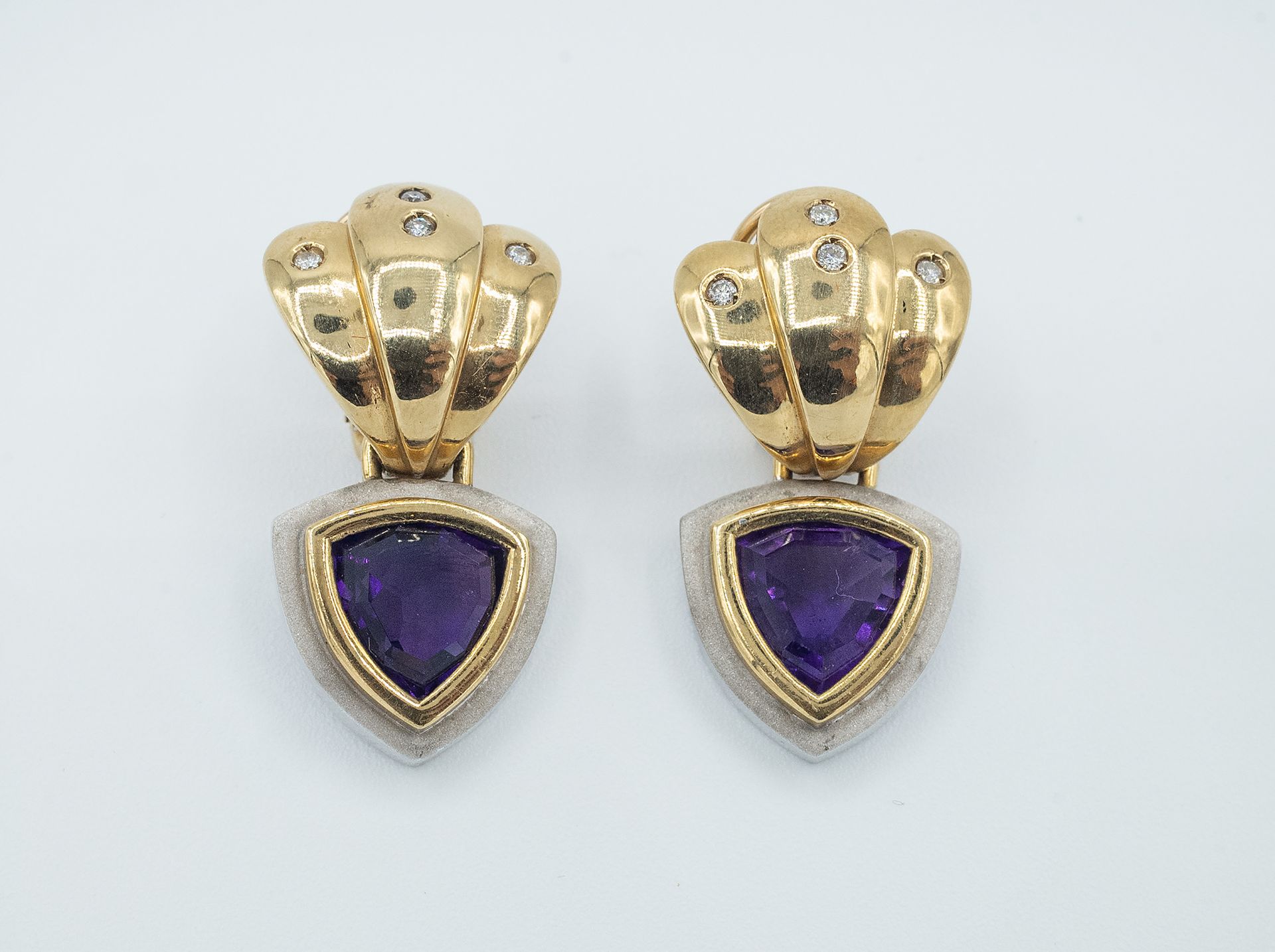 A pair of long earrings with amethysts and diamonds