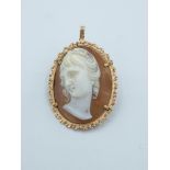 A second half of 20th century cameo pendant brooch with an 18 k. yellow gold setting