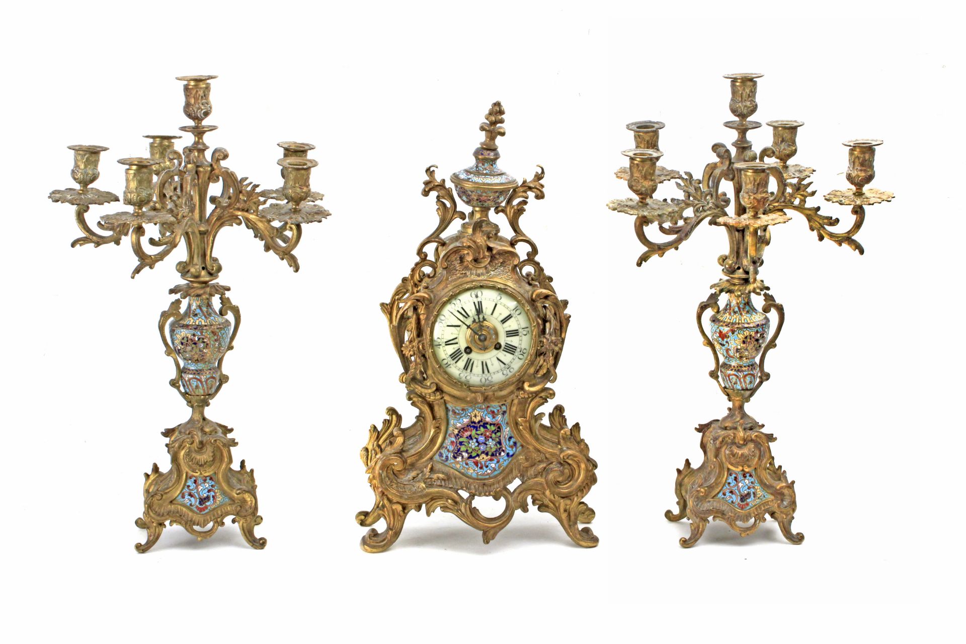 A 19th century French bronze mantel clock grnished with two candlelabras