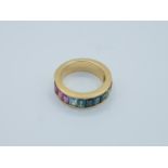 A rainbow half eternity ring with coloured stones