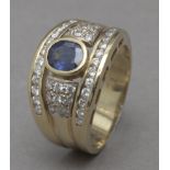 A sapphire and diamonds ring with an 18k. yellow gold setting