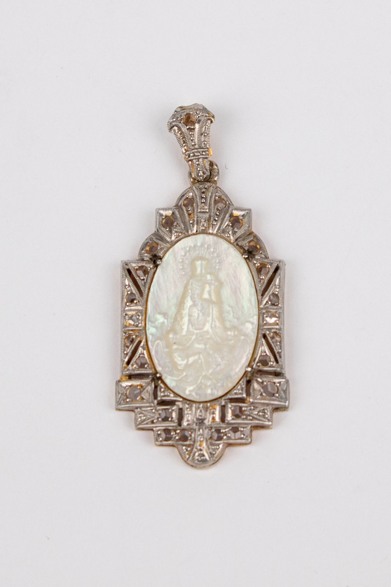 An Art-Déco gold, platinum, diamonds and mother of pearl devotional medal circa 1930