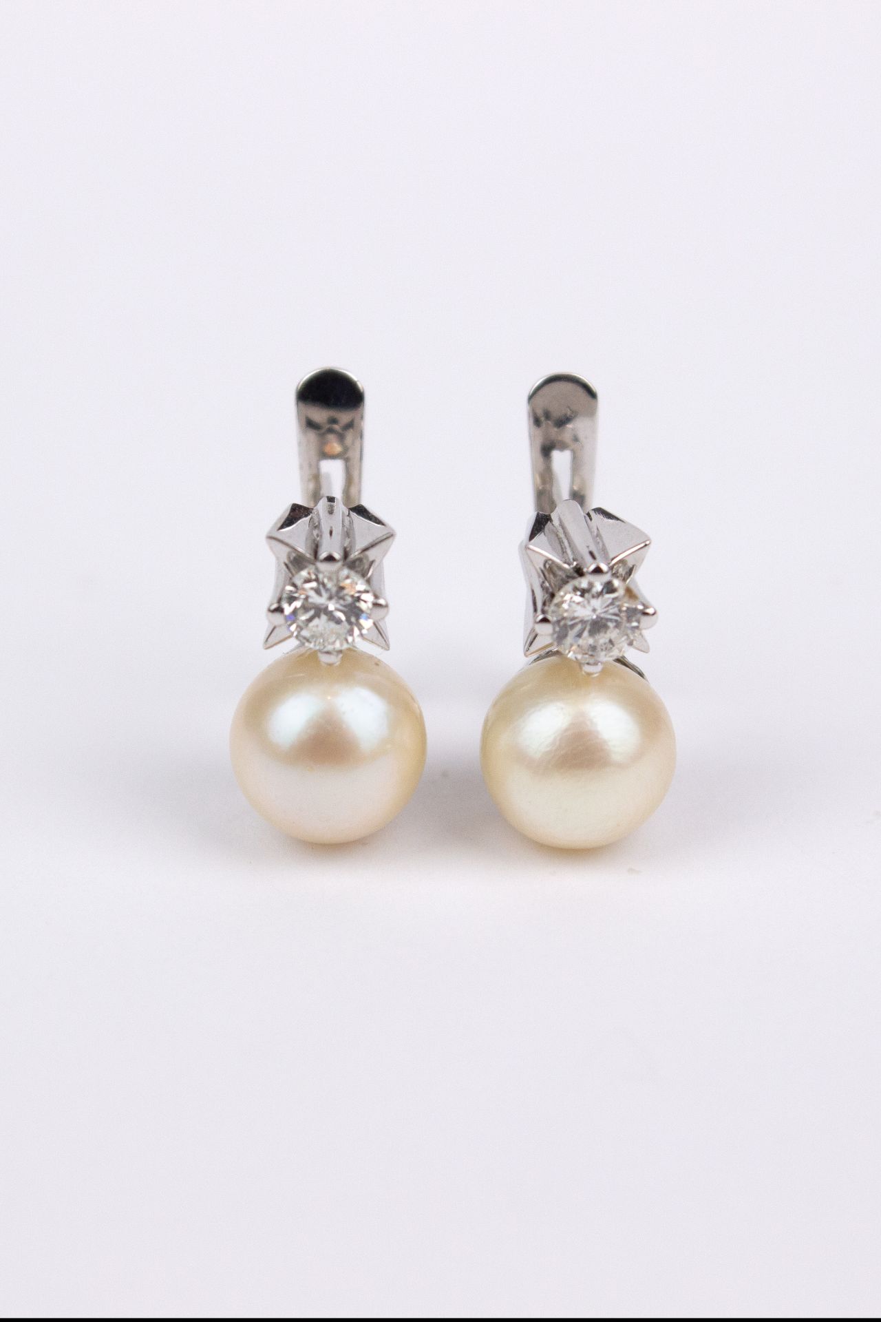 A pair of ‘toi et moi’ brilliant cut diamonds and culture pearls earrings