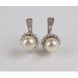 Carreras. A pair of diamond and cultured pearls cluster earrings