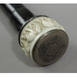 A 19th century walking stick with a carved ivory handle and an ebony shaft