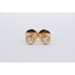 A pair of 18k. yellow gold and diamond stud earrings